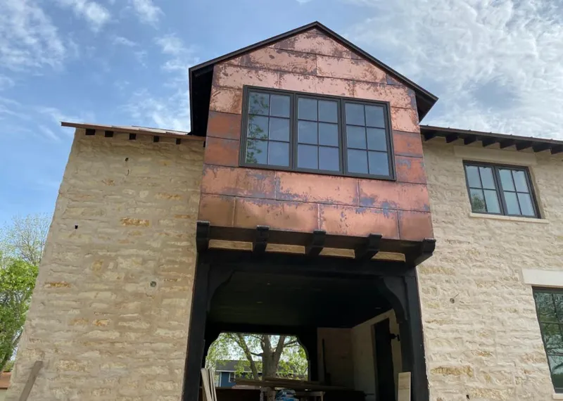 Copper metal panel facade on a stone building for Skylight Installation in Claremont