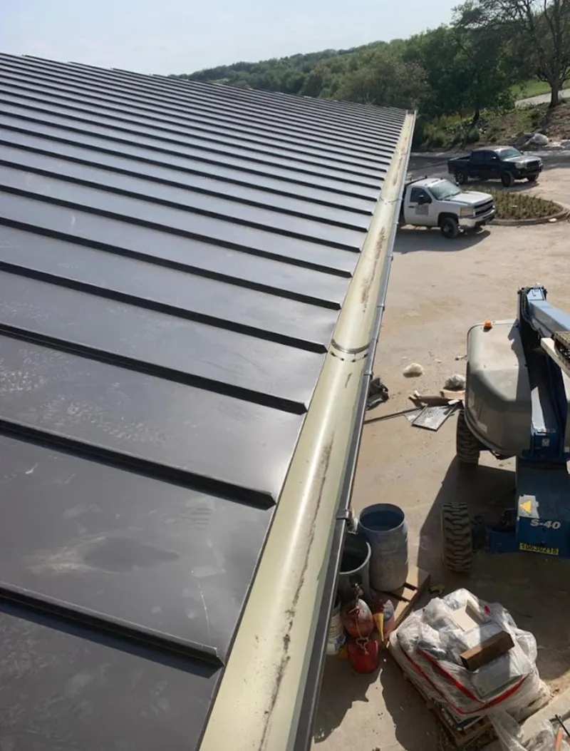 Standing seam panel and gutter detail on a metal roofing jobsite in Claremont